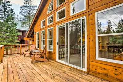 a wooden house with a deck with a bench and windows at Hot Tub Access, Near Skiing Tahoe Donner Cabin in Truckee