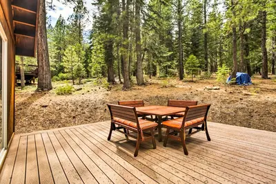 a wooden deck with a table and two chairs at Hot Tub Access, Near Skiing Tahoe Donner Cabin in Truckee