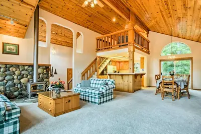 a living room with a wooden ceiling and a staircase at Hot Tub Access, Near Skiing Tahoe Donner Cabin in Truckee