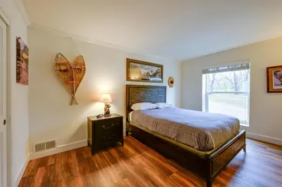 a bedroom with a bed and a lamp on a night stand at 7 Mi to Bass Lake! Spacious Mudge Ranch Retreat in Coarsegold