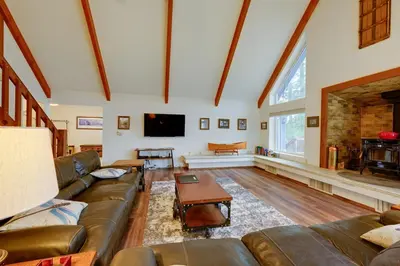 a large living room with a couch and a tv at 7 Mi to Bass Lake! Spacious Mudge Ranch Retreat in Coarsegold