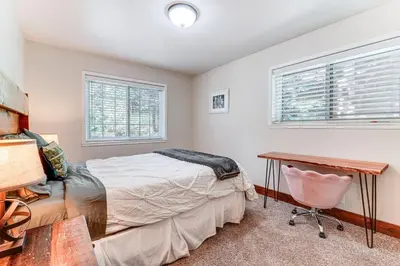 a bedroom with a bed and a desk and windows at Less Than 15 Mi to 6 Ski Resorts Tahoe Donner Escape! in Truckee