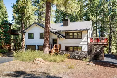 a house in the woods with a tree at Less Than 15 Mi to 6 Ski Resorts Tahoe Donner Escape! in Truckee