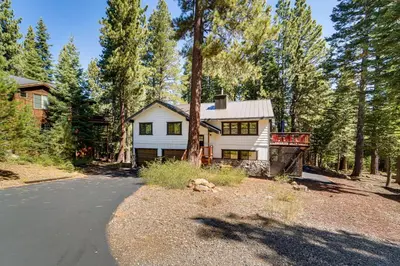 a white house in the middle of a forest at Less Than 15 Mi to 6 Ski Resorts Tahoe Donner Escape! in Truckee