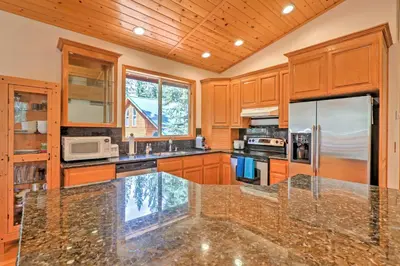 a kitchen with wooden cabinets and a granite counter top at Family Tahoe Donner Retreat Less Than 2 Mi to Downhill Ski in Truckee