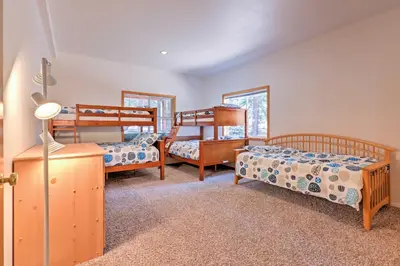 a bedroom with three bunk beds and a lamp at Family Tahoe Donner Retreat Less Than 2 Mi to Downhill Ski in Truckee
