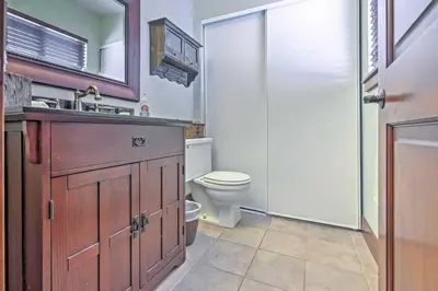 a bathroom with a toilet and a sink and a mirror at Private Deck and Community Pool Incline Village Gem in Incline Village