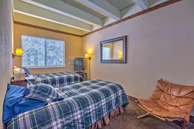 a room with two beds and a mirror and a chair at Private Deck and Community Pool Incline Village Gem in Incline Village