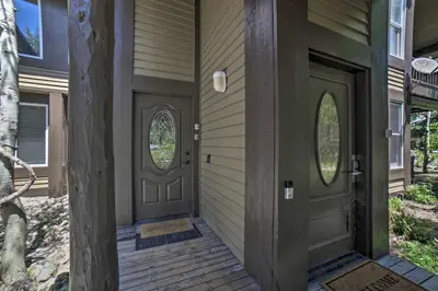 a front door of a house with two windows at Mammoth Lakes Vacation Rental with Community Hot Tub in Mammoth Lakes
