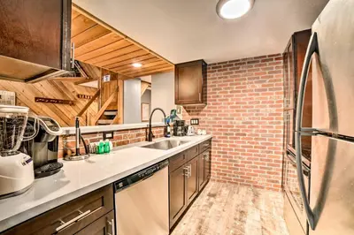 a kitchen with a sink and a brick wall at Renovated Mammoth Lakes Retreat with Private Balcony in Mammoth Lakes