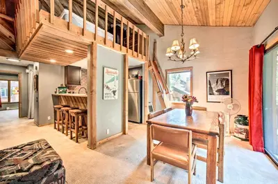 a dining room with a wooden table and chairs at Renovated Mammoth Lakes Retreat with Private Balcony in Mammoth Lakes
