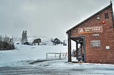 a building with a bench in a snow covered field at Cabin Less Than 2 Mi to Tahoe Donner Downhill Ski Resort in Truckee