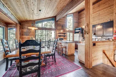 a dining room and kitchen in a log cabin at Free Ski Shuttle! Spacious Northstar Resort Cabin in Truckee