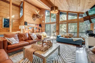 a living room with a couch and a table at Free Ski Shuttle! Spacious Northstar Resort Cabin in Truckee