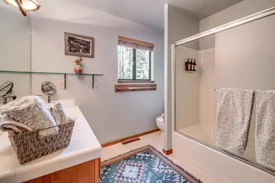 a bathroom with a shower and a sink and a toilet at Free Ski Shuttle! Spacious Northstar Resort Cabin in Truckee