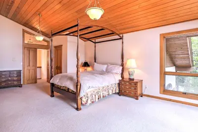 a bedroom with a four poster bed and a wooden ceiling at Mtn and Lake Views Incline Village Ski Chalet in Incline Village