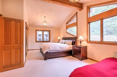 a bedroom with a bed and a window at Mtn and Lake Views Incline Village Ski Chalet in Incline Village