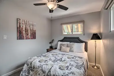 a bedroom with a bed and a ceiling fan at Ski, Hike and Unwind Cozy Carson City Duplex! in Carson City