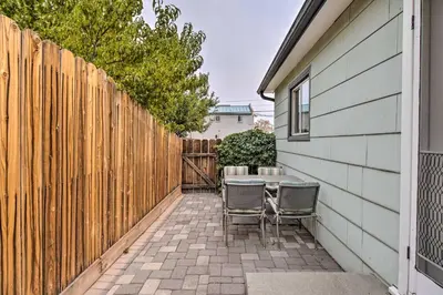 a patio with a table and chairs next to a fence at Ski, Hike and Unwind Cozy Carson City Duplex! in Carson City
