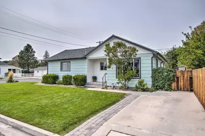 a blue house with a fence and a yard at Ski, Hike and Unwind Cozy Carson City Duplex! in Carson City