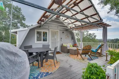 a patio with a table and chairs on a deck at Mariposa Home Furnished Patio and Sierra Mtn Views in Mariposa
