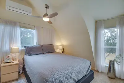 a bedroom with a bed and two windows at Mariposa Home Furnished Patio and Sierra Mtn Views in Mariposa