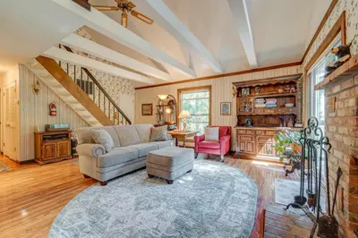 a living room with a couch and a table at Rustic Riverfront Truckee Cabin with Deck and BBQ in Truckee