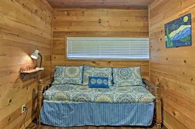 a bedroom with a bed in a log cabin at Cozy Home with Patio Near Yosemite National Park! in Mariposa
