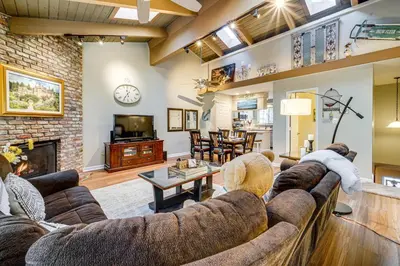 a living room with a couch and a fireplace at 1 Mi to Diamond Peak Ski Resort Condo with Pool in Incline Village