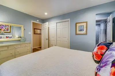 a bedroom with a bed and a dresser and a mirror at 1 Mi to Diamond Peak Ski Resort Condo with Pool in Incline Village
