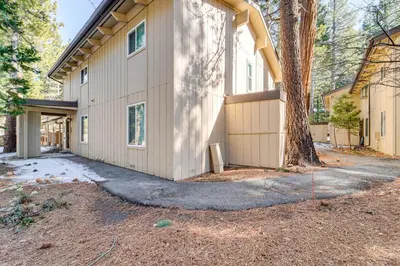 a house with a tree in front of it at 1 Mi to Diamond Peak Ski Resort Condo with Pool in Incline Village