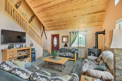 a living room with two couches and a tv at 4 Mi to Pine Lake Hathaway Pines Cabin with Deck in Hathaway Pines