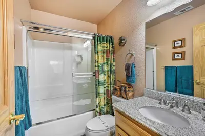 a bathroom with a shower and a sink and a toilet at 4 Mi to Pine Lake Hathaway Pines Cabin with Deck in Hathaway Pines