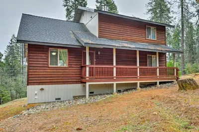 a log cabin with a large deck on a hill at 4 Mi to Pine Lake Hathaway Pines Cabin with Deck in Hathaway Pines