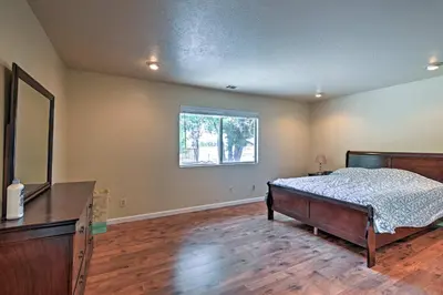 a bedroom with a bed and a dresser and a window at Remodeled and Cozy Gilroy Guest House Near Downtown! in Gilroy