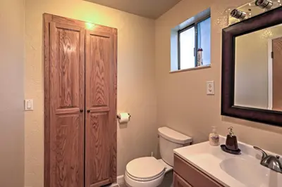 a bathroom with a toilet and a sink and a mirror at Remodeled and Cozy Gilroy Guest House Near Downtown! in Gilroy