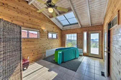 a room with wooden walls and a ceiling fan at Working Vineyard and Private Pool Villa in Plymouth in Plymouth