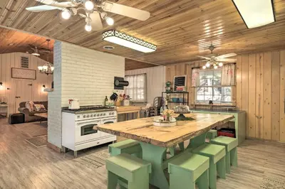 a kitchen with a large wooden table and green chairs at Strawberry Hill Cabin 5 Mi to Skiing and Lake in Strawberry