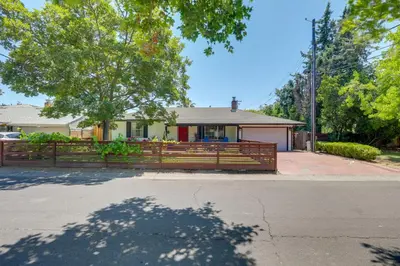 a house with a wooden fence in front of it at Family Home with Pool about 7 Mi to Downtown Sacramento! in Sacramento