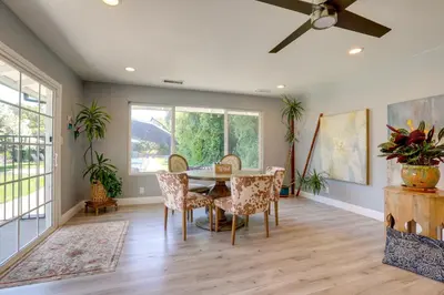 a dining room with a table and chairs and a ceiling fan at Family Home with Pool about 7 Mi to Downtown Sacramento! in Sacramento