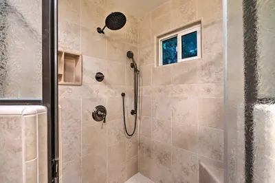 a bathroom with a shower with a glass door at Luxurious Downtown Lodi Apartment in Wine Country! in Lodi