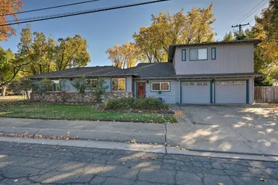 a house with two garage doors on a street at Luxurious Downtown Lodi Apartment in Wine Country! in Lodi