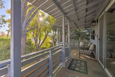 a porch of a house with a bench on it at Luxurious Downtown Lodi Apartment in Wine Country! in Lodi