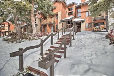 a group of stairs in the snow in front of a building at The Mammoth Lodge by Hiking, Lakes, Skiing and More! in Mammoth Lakes