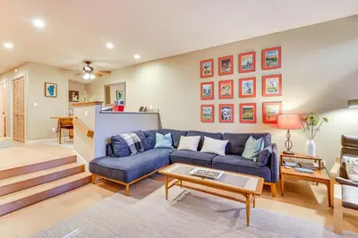 a living room with a blue couch and a table at 2 Mi to Diamond Peak! Corner-Unit Condo with Hot Tub in Incline Village