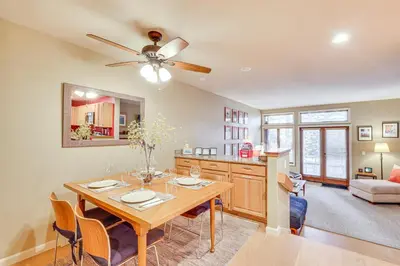 a kitchen and dining room with a table and a ceiling fan at 2 Mi to Diamond Peak! Corner-Unit Condo with Hot Tub in Incline Village