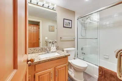 a bathroom with a toilet and a shower and a sink at 2 Mi to Diamond Peak! Corner-Unit Condo with Hot Tub in Incline Village