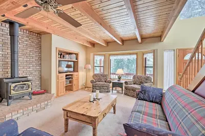 a living room with a couch and a wood stove at Near Bear Valley Peaceful Arnold Home with Hot Tub in Arnold