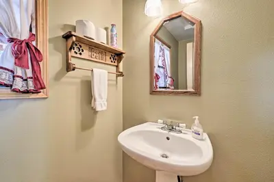a bathroom with a sink and a mirror at Near Bear Valley Peaceful Arnold Home with Hot Tub in Arnold