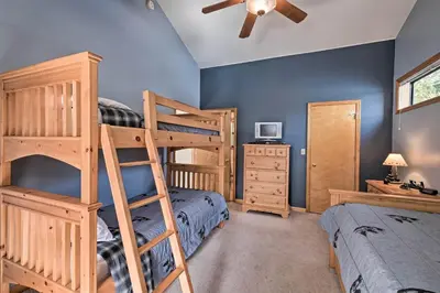 a bedroom with two bunk beds and a ceiling fan at Near Bear Valley Peaceful Arnold Home with Hot Tub in Arnold